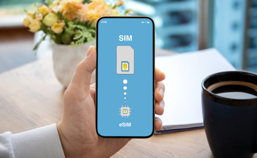 A man is holding a smartphone that displays both the Physical SIM﻿ and eSIM﻿ symbols on its screen, illustrating the coexistence of the two SIM technologies