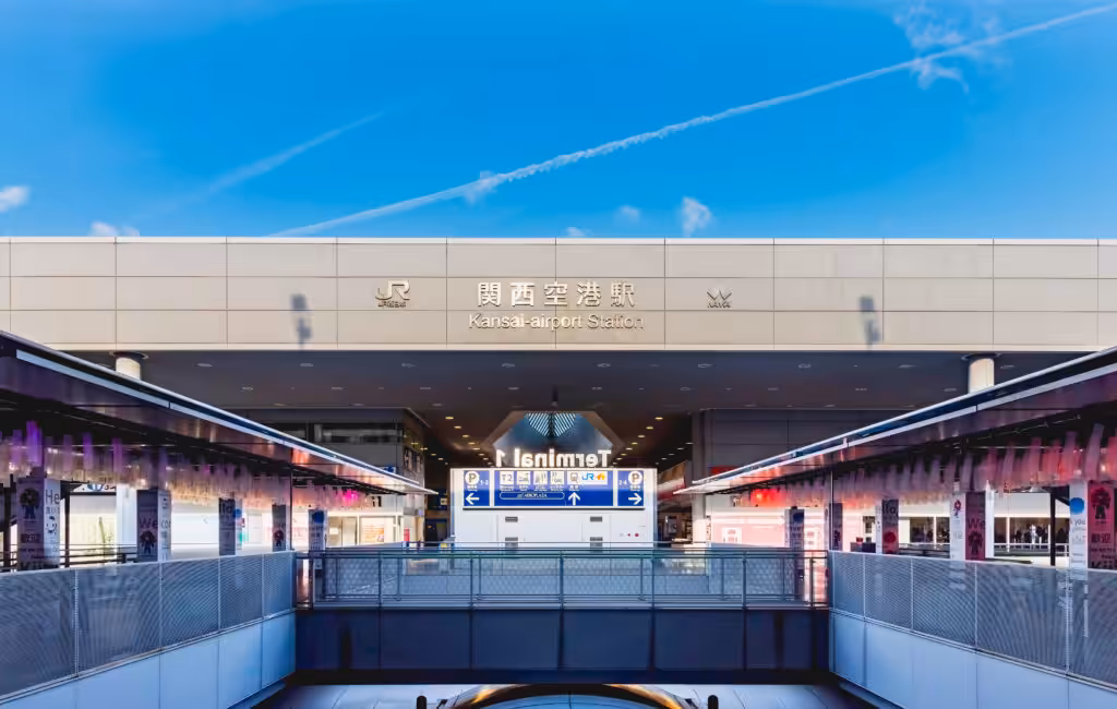 A quiet morning scene in front of Kansai Airport Station, captured under a clear blue sky