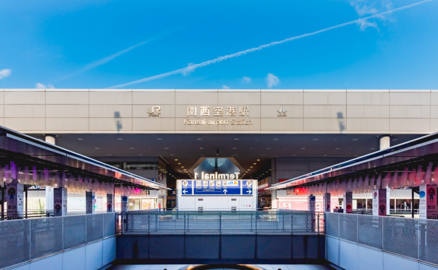 A quiet morning scene in front of Kansai Airport Station, captured under a clear blue sky