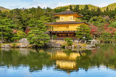 Golden Pavilion reflection in a small pond with colourful maple garden in autumn at Kinkaku-ji Temple, Kyoto, Japan