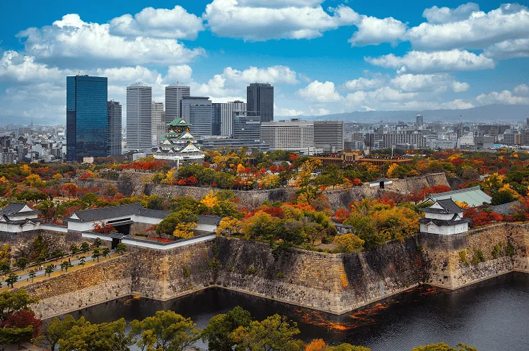 Vibrant cityscape of Osaka, where heritage blends with contemporary life, capturing the blend of natural beauty and city life during the fall season